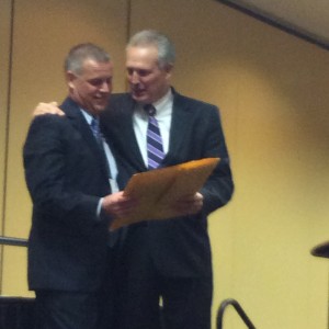 2013-2014 ITLA President Mark Ladendorf congratulates Dan Ladendorf with the Trial Lawyer of the Year plaque